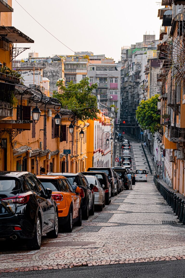 cars parked on sidewalk near buildings during daytime